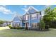 Inviting two-story home with blue siding, red shutters, and well-manicured landscaping at 700 Ridgeway Ct, Canton, GA 30114