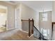 Hallway featuring wood banister, a view of the entry, a window and a view into the bathroom at 700 Ridgeway Ct, Canton, GA 30114