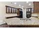 Modern kitchen with granite countertops, dark wood cabinets, and stainless steel appliances at 700 Ridgeway Ct, Canton, GA 30114