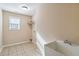 Functional laundry room with tile flooring, utility sink, storage shelving, and natural light from a window at 700 Ridgeway Ct, Canton, GA 30114