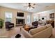 Cozy living room with fireplace, ceiling fan, open to dining area and comfortable seating at 700 Ridgeway Ct, Canton, GA 30114