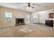 Open-concept living room featuring a cozy stone fireplace and seamless flow into dining area at 700 Ridgeway Ct, Canton, GA 30114