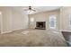 Spacious living room with a stone fireplace, large windows, and access to the backyard at 700 Ridgeway Ct, Canton, GA 30114