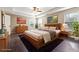 Spacious main bedroom with tray ceiling, hardwood floors, and natural light from large windows at 700 Ridgeway Ct, Canton, GA 30114