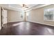 Spacious primary bedroom with tray ceilings, large windows, and wood-look flooring, offering a luxurious retreat at 700 Ridgeway Ct, Canton, GA 30114