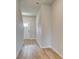 Inviting hallway featuring wood-look flooring and a bright white front door at 110 Alpine Rd, Fairburn, GA 30213