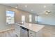 Modern kitchen island featuring a stainless steel dishwasher and sink overlooking a living area at 110 Alpine Rd, Fairburn, GA 30213