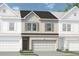 Charming townhome showcasing a brick facade and a convenient two-car garage at 1234 Ravencliff Dr # 81, Austell, GA 30168