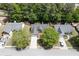 Aerial view showcasing the home's location on a tree-lined street and well-manicured front yard at 2175 Charleston Oak Cir, Lawrenceville, GA 30043