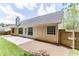 View of the home's backyard featuring a concrete patio area, wood fence, and well-maintained lawn at 2175 Charleston Oak Cir, Lawrenceville, GA 30043
