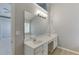 Bright bathroom with dual sinks, large mirror and a view into bedroom at 2175 Charleston Oak Cir, Lawrenceville, GA 30043