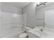 Bright bathroom with a tub-shower combo, toilet, and single sink vanity at 2175 Charleston Oak Cir, Lawrenceville, GA 30043