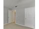 Neutral bedroom with carpet, white trim, vaulted ceiling, and 2 doors at 2175 Charleston Oak Cir, Lawrenceville, GA 30043