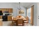 Bright dining area featuring a wood table, wood chairs and tan window treatments at 2175 Charleston Oak Cir, Lawrenceville, GA 30043