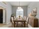 Elegant dining room with a large window, perfect for Gathering meals and entertaining guests at 2175 Charleston Oak Cir, Lawrenceville, GA 30043