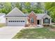 Charming single-Gathering home featuring a two-car garage and landscaped front yard at 2175 Charleston Oak Cir, Lawrenceville, GA 30043