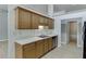 Galley kitchen featuring wood cabinets, light countertops, stainless steel appliances, and light floors at 2175 Charleston Oak Cir, Lawrenceville, GA 30043