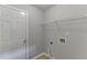 Neutral laundry room with door, shelf, and hookups at 2175 Charleston Oak Cir, Lawrenceville, GA 30043