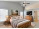 Vaulted main bedroom featuring a ceiling fan, wood furniture, and two windows at 2175 Charleston Oak Cir, Lawrenceville, GA 30043