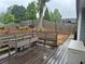Cozy backyard including an expansive wooden deck, a gray fence and string lights at 2298 Hillbriar Dr, Buford, GA 30518