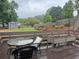 A spacious backyard featuring a wooden deck with plants and furniture, a shed and string lights at 2298 Hillbriar Dr, Buford, GA 30518
