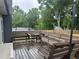 A well-maintained backyard featuring a wooden deck with furniture, a gray fence and string lights at 2298 Hillbriar Dr, Buford, GA 30518