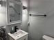 Contemporary bathroom featuring a sleek vanity, modern lighting, and a stylish mirror at 2298 Hillbriar Dr, Buford, GA 30518