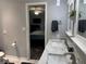 View from the bathroom into the main bedroom showcasing the suite layout, fan, and TV at 2298 Hillbriar Dr, Buford, GA 30518