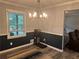 The dining room has wood floors and is filled with natural light, with a view to the Gathering room at 2298 Hillbriar Dr, Buford, GA 30518