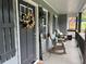 The front porch features rocking chairs and a decorative wreath hanging on the front door at 2298 Hillbriar Dr, Buford, GA 30518