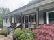 Inviting front porch with decorative accents and comfortable seating, perfect for relaxing at 2298 Hillbriar Dr, Buford, GA 30518
