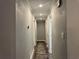 Well-lit hallway with a neutral color scheme and carpet runner leading to other rooms at 2298 Hillbriar Dr, Buford, GA 30518