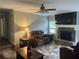Cozy living room with a stone fireplace, ceiling fan, and plenty of space to relax at 2298 Hillbriar Dr, Buford, GA 30518
