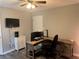 Office space featuring dark accent wall, with desk, dual monitors, and mounted TV at 2298 Hillbriar Dr, Buford, GA 30518