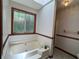 Relaxing bathroom with a large soaking tub, window, and neutral tile flooring at 3436 Finglas Dr, Marietta, GA 30008