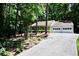 Lovely home nestled among trees, featuring a long driveway and an attached two-car garage at 3436 Finglas Dr, Marietta, GA 30008