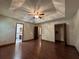 Spacious main bedroom with hardwood floors, tray ceiling, and ceiling fan at 3436 Finglas Dr, Marietta, GA 30008