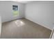 Clean and bright bedroom features neutral carpet and a view to the outdoors at 4504 Cedar Ridge Trl, Stone Mountain, GA 30083