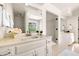 Bright bathroom featuring white cabinetry, double sinks and granite countertops at 720 Belgrave Ln, Tucker, GA 30084