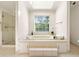 Bright bathroom with a large soaking tub and a separate glass-enclosed shower at 720 Belgrave Ln, Tucker, GA 30084