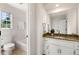 Bathroom featuring granite countertops, a window view, and a shower-tub combo at 720 Belgrave Ln, Tucker, GA 30084