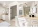 Bathroom with white cabinetry, double sinks and granite countertops at 720 Belgrave Ln, Tucker, GA 30084