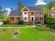 Charming brick two-story home with manicured lawn and mature trees, offering classic curb appeal at 720 Belgrave Ln, Tucker, GA 30084