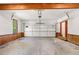Spacious two-car garage with wood trim and a garage door that has multiple window panels at 720 Belgrave Ln, Tucker, GA 30084