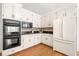 Well-equipped kitchen featuring modern appliances, white cabinetry, and ample counter space, a culinary delight at 720 Belgrave Ln, Tucker, GA 30084