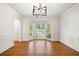 Elegant living room with hardwood floors, bay windows, and decorative molding, offering a refined space at 720 Belgrave Ln, Tucker, GA 30084