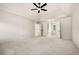 Main bedroom showcasing plush carpet and open doorway leading to a well-lit ensuite with tub and shower at 720 Belgrave Ln, Tucker, GA 30084