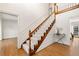 Staircase featuring wood and white trim, leading to the upper level of the home with hardwood floors in the foyer at 720 Belgrave Ln, Tucker, GA 30084