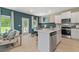 Open-concept kitchen with an island, stainless steel appliances, and a view of the backyard at 112 Alpine Rd, Fairburn, GA 30213