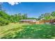 Expansive backyard with a firepit, large grassy area and fenced perimeter at 2133 Bird Ln, Snellville, GA 30078